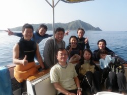 渡名喜島を背に、みんなでパチリ。 渡名喜島を背に、みんなでパチリ。